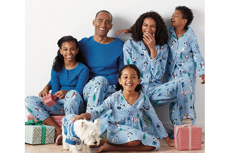 family wearing matching pjs with their dog
