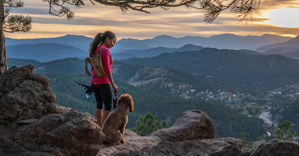 girl hiking with dogs