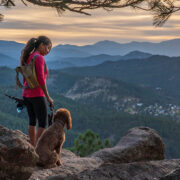 girl hiking with dogs