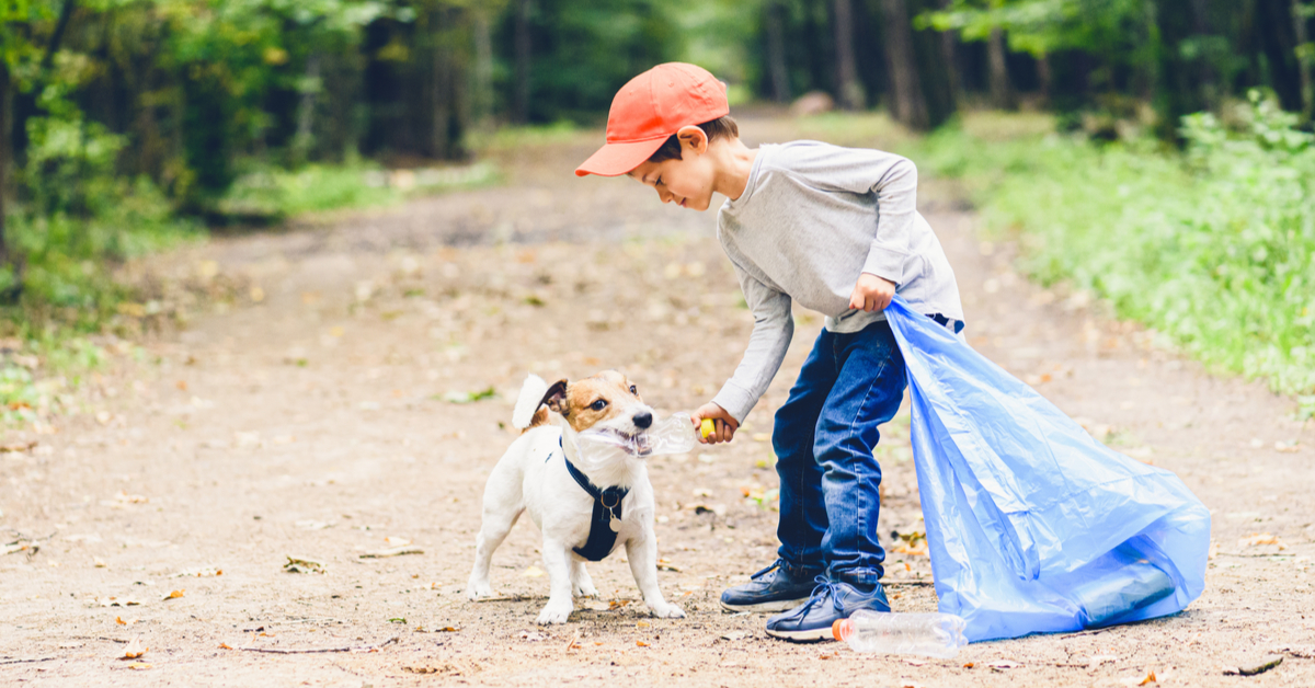 dog and child picking up trash earth day every day