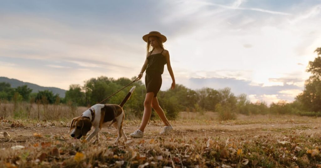 girl taking her dog on a sniff walk