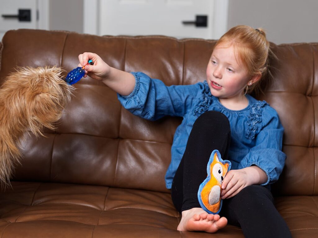 child with dog on couch