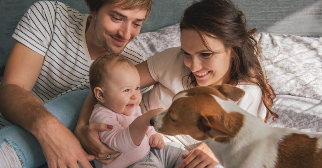 family introducing dog to new baby