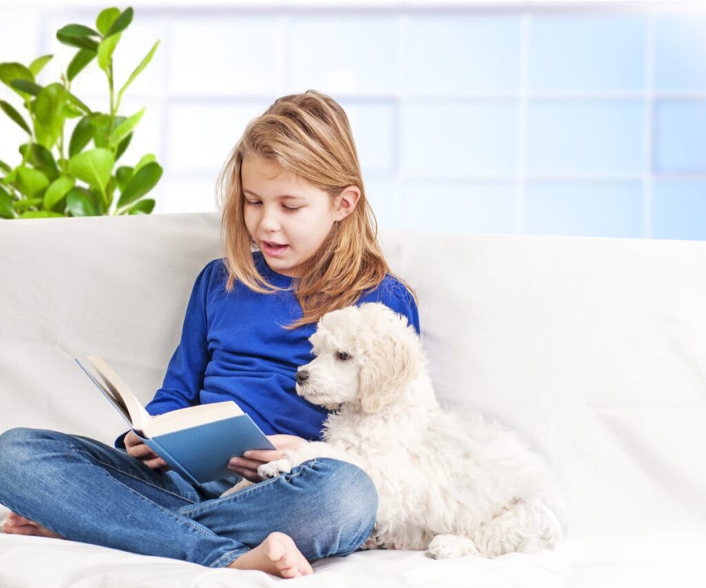 girl reading to dog